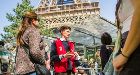 Guide talking about the Eiffel Tower to a group of tourists
