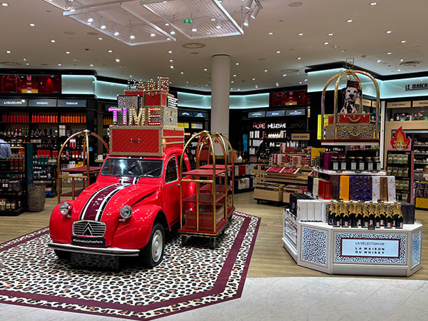 Red car 2CV parks in the store PARIS TIME