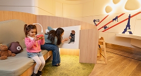 Mum with her children in the airport terminal baby lounge