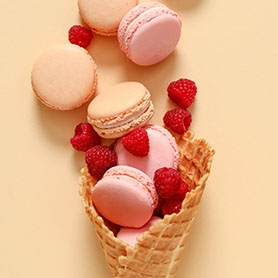 macaroons and raspberries in a cookie cone