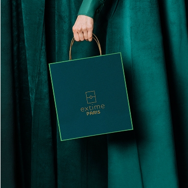 Main de femme tenant un sac de shopping Extime Paris